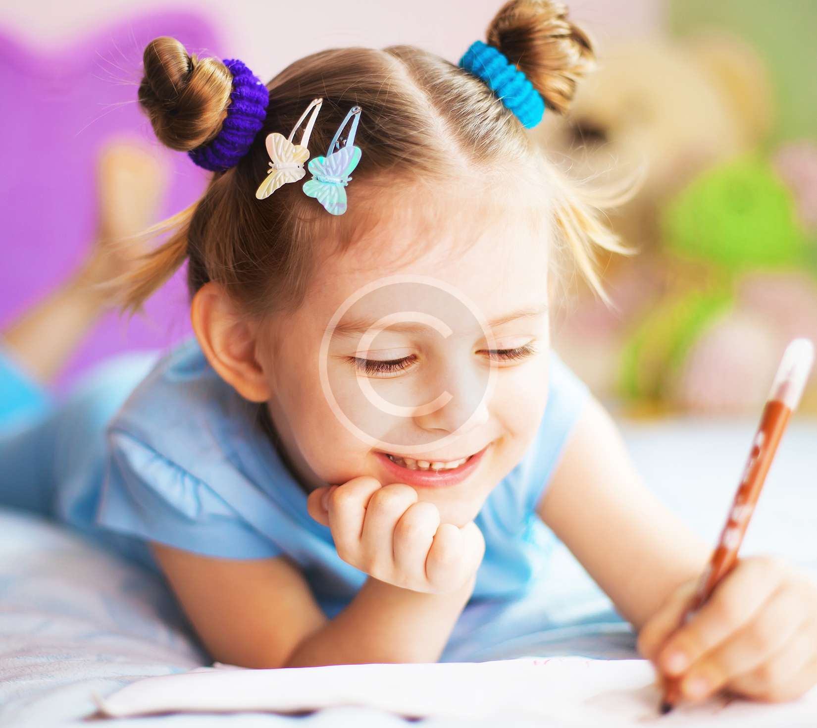 Happy little girl painting in her room